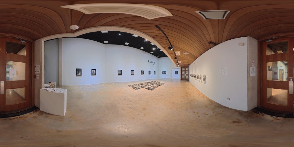 A 360 degree photograph of the Residue exhibition, showing framed artworks and a floor installation beneath a curved timber ceiling.